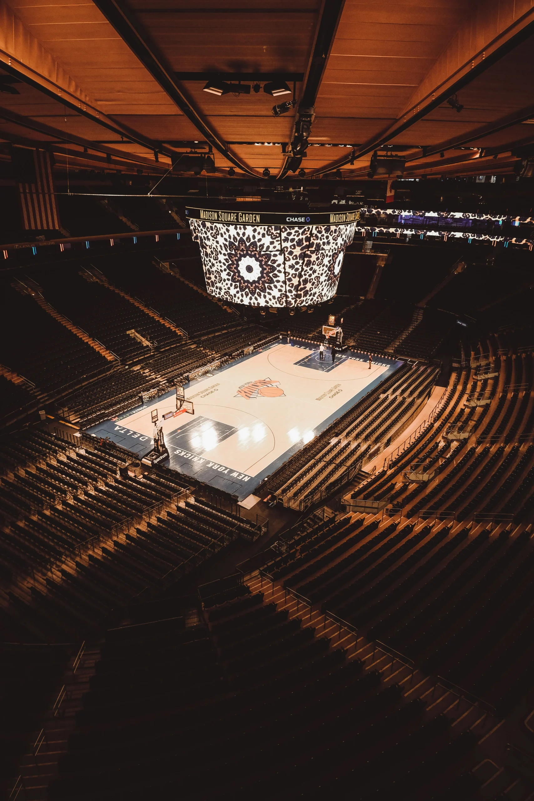 Foto por <a href="https://unsplash.com/@bypaul?utm_source=unsplash&utm_medium=referral&utm_content=creditCopyText">With Paul</a> on <a href="https://unsplash.com/photos/a-basketball-court-in-a-large-arena-with-fans-eEnokNtvnoo?utm_source=unsplash&utm_medium=referral&utm_content=creditCopyText">Unsplash</a>