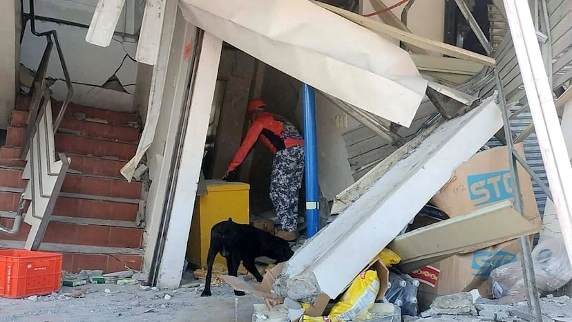 Un miembro de la Guardia Costera participando en las labores de rescate tras el derrumbe de un edificio en General Santos (Filipina), este lunes.